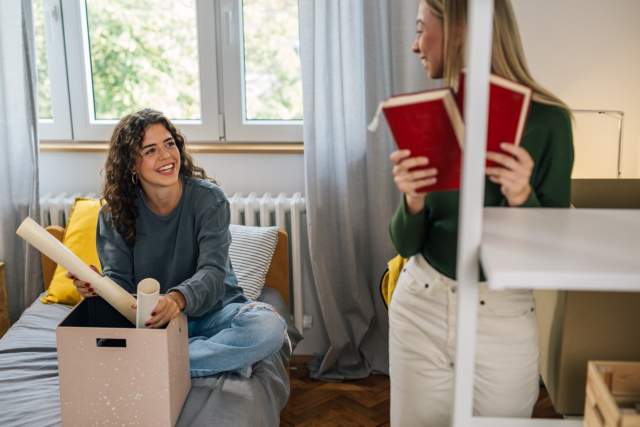 Students unpacking in dorm room