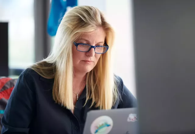 Flywire's Barbara Cousins working at laptop